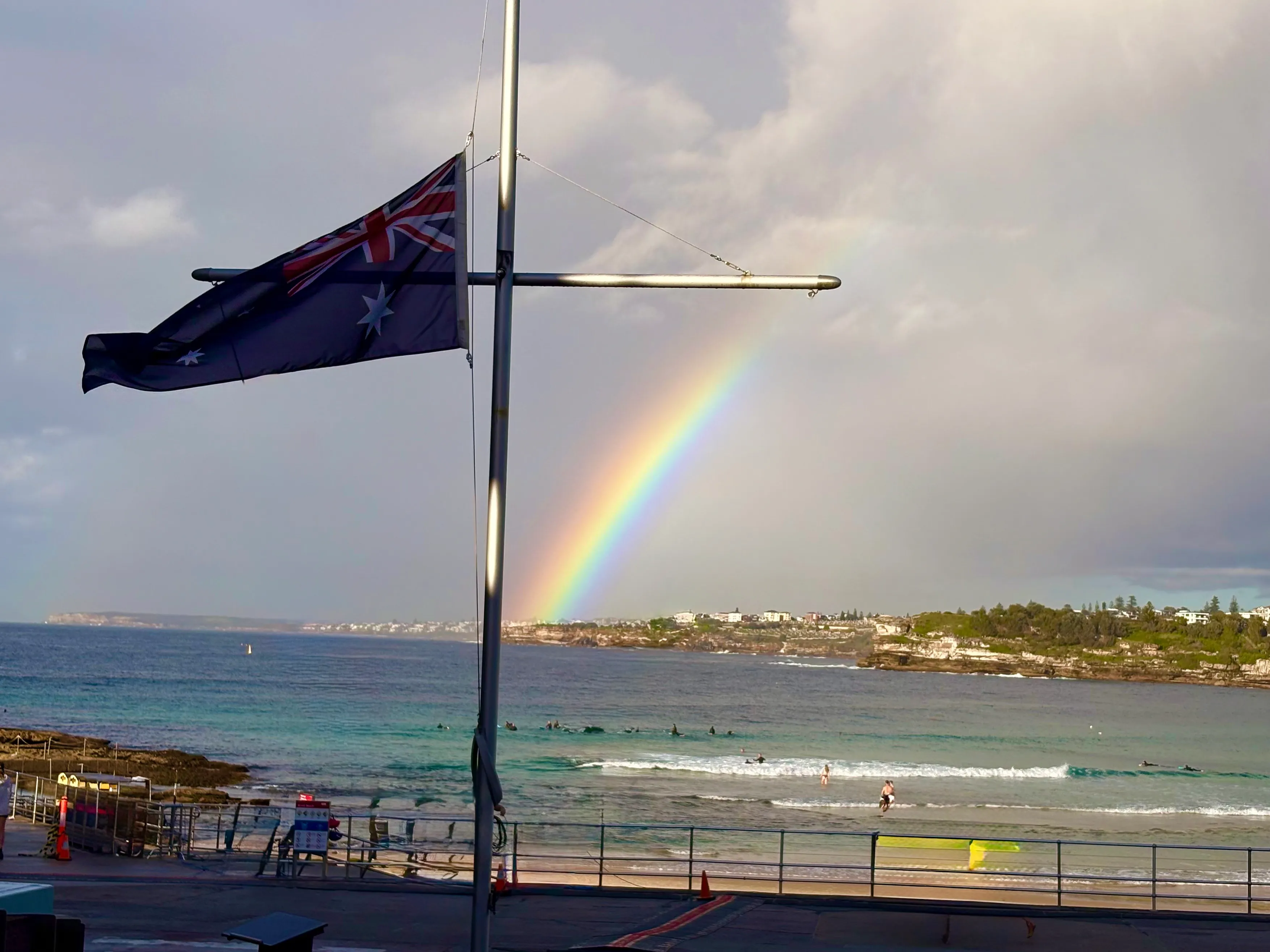 Bondi Beach beneath a rainbow